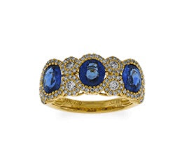 18K yellow gold diamond and sapphire ring featuring 3 oval s...